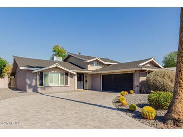 Updated single-story home with a large driveway and desert landscaping at 8614 E Valley View Rd, Scottsdale, AZ 85250