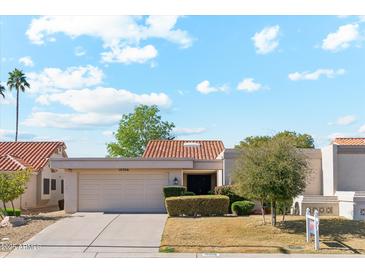 Charming single-story home with desert landscaping, two-car garage, and classic southwest architecture at 10206 N 105Th Way, Scottsdale, AZ 85258