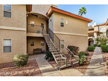 Attractive exterior of a two-story condo building with stairs and landscaping at 10410 N Cave Creek Rd # 2060, Phoenix, AZ 85020