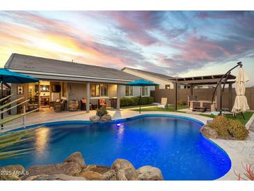 Inviting backyard pool with a spacious patio and pergola at 11971 E Chevelon Trl, Gold Canyon, AZ 85118