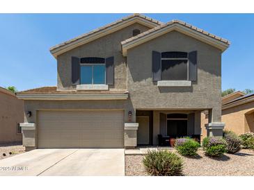 Charming two-story home featuring a two-car garage and a welcoming front porch at 12378 W Roma Ave, Avondale, AZ 85392