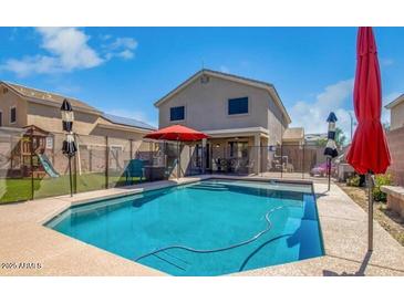 This backyard features a refreshing pool, perfect for outdoor relaxation and enjoyment at 12378 W Roma Ave, Avondale, AZ 85392