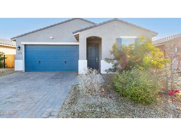 One-story house with blue garage door and landscaped front yard at 1523 S 223Rd Dr, Buckeye, AZ 85326