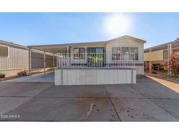 Single-wide manufactured home with carport and elevated deck at 17200 W Bell Rd # 517, Surprise, AZ 85374