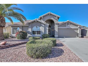 Single-story home with attractive landscaping and a two-car garage at 18840 N 83Rd Ln, Peoria, AZ 85382