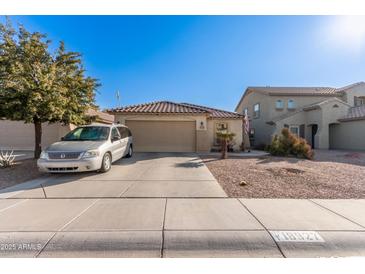 Single-story home with a two-car garage and desert landscaping at 18927 N Leland Rd, Maricopa, AZ 85138