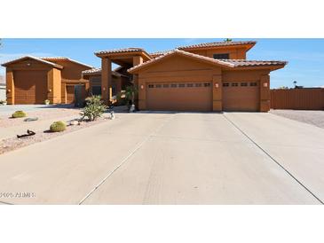 Two-story house with a three-car garage and desert landscaping at 2837 N Whiting Cir, Mesa, AZ 85213