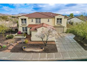 Two-story house with tile roof, landscaped yard, and a three-car garage at 30773 N 129Th Ave, Peoria, AZ 85383