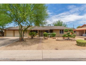 Ranch style home with landscaped yard and two-car garage at 3136 W Sunnyside Ave, Phoenix, AZ 85029