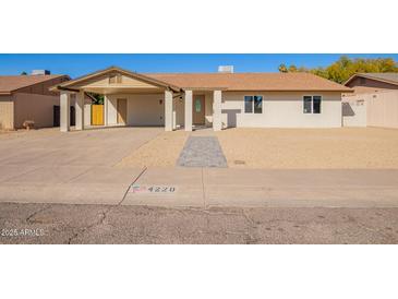 Charming single-story home featuring a covered carport and desert landscaping at 4220 W State Ave, Phoenix, AZ 85051