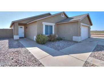 Single-story house with a two-car garage and landscaped front yard at 5175 W Warren Dr, Casa Grande, AZ 85194