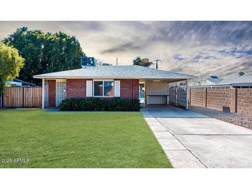 Brick ranch house with carport, spacious yard, and wooden fence at 621 W Howe St, Tempe, AZ 85281