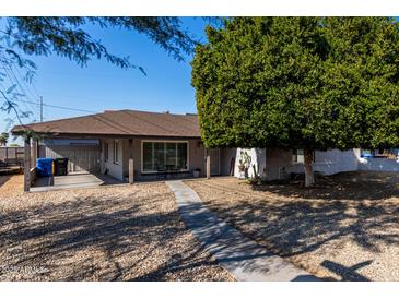 House exterior with covered patio and mature tree at 7004 N 11Th Way, Phoenix, AZ 85020