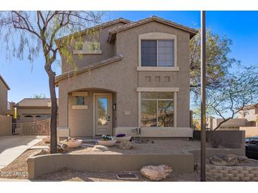 Two-story house with neutral exterior, landscaping, and a two-car garage at 7235 E Norwood St, Mesa, AZ 85207