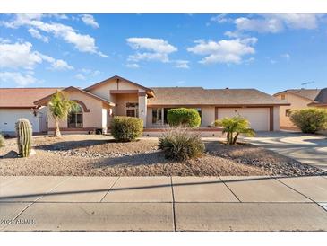 Single-story home with a two-car garage and desert landscaping at 13907 W Gable Hill Dr, Sun City West, AZ 85375