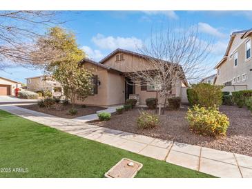 Charming single-story home with well-maintained landscaping and inviting curb appeal at 14765 W Alexandria Way, Surprise, AZ 85379