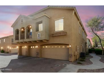 Modern townhome showcasing a balcony, three-car garage, and well-maintained landscaping at 2150 E Bell Rd # 1090, Phoenix, AZ 85022