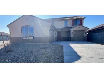 Two-story house with a large driveway and desert landscaping at 23285 W Florence Ave, Buckeye, AZ 85326