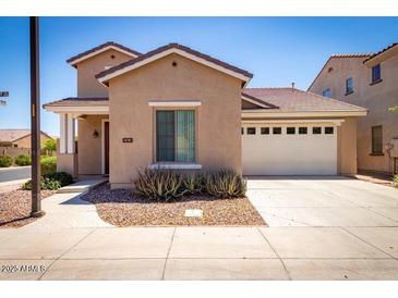 Charming single-Gathering home with a well-maintained lawn, a two-car garage, and desert landscaping at 263 W Rosemary Dr, Chandler, AZ 85248