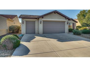 Two-car garage and desert landscaping enhance this home's curb appeal at 26335 W Burnett Rd, Buckeye, AZ 85396