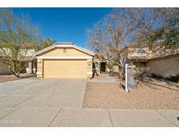 Cute one-story house with a two-car garage and desert landscaping at 12000 W Bloomfield Rd, El Mirage, AZ 85335