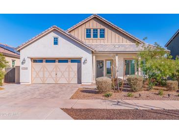 Charming single-story home with a two-car garage and well-maintained front yard landscaping at 12349 N 145Th Ave, Surprise, AZ 85379