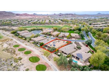 An aerial view of a single-Gathering home with solar panels close to the golf course in a desert setting at 28247 N 128Th Dr, Peoria, AZ 85383