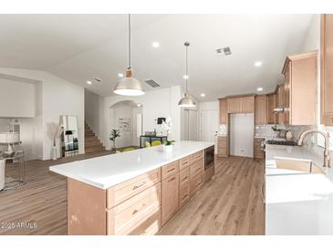 Modern kitchen with light wood cabinets, quartz countertops, and stainless steel appliances at 3258 E Dover St, Mesa, AZ 85213