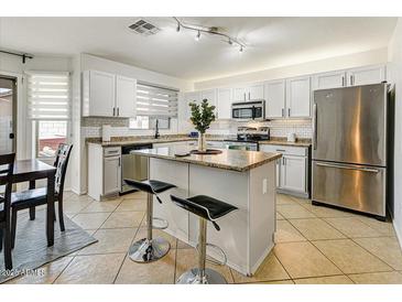 Modern kitchen with island, stainless steel appliances, and granite countertops at 40136 N Costa Del Sol Dr, San Tan Valley, AZ 85140