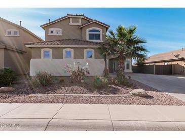 Charming two-story home with a desert-landscaped front yard and lovely architectural details at 42531 W Chisholm Dr, Maricopa, AZ 85138