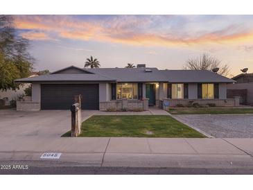 Charming single-story home with a well-maintained front yard and attached two-car garage at 5045 W Mescal St, Glendale, AZ 85304