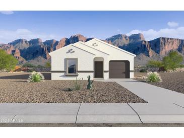 White stucco house with brown garage door and desert landscaping; mountain views at 5552 E Rock Bush Ln, San Tan Valley, AZ 85140