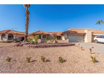 Attractive single-story home with desert landscaping and a two-car garage at 10662 N 33Rd Pl, Phoenix, AZ 85028
