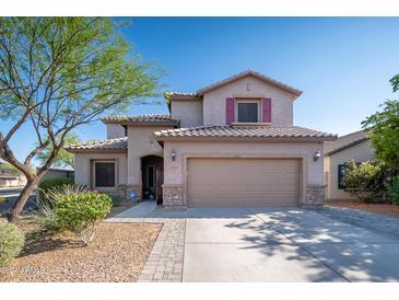 Two-story house with a beige exterior, two-car garage, and landscaping at 10789 W Yearling Rd, Peoria, AZ 85383