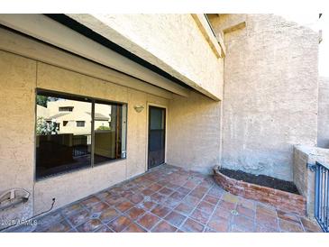 Private patio with tiled flooring and access to the unit at 10828 N Biltmore Dr # 115, Phoenix, AZ 85029
