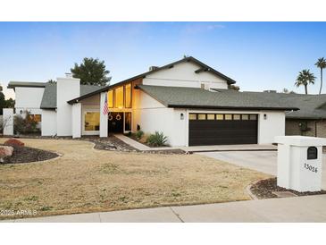 Stunning contemporary home with a clean design and landscaped lawn at 13026 N 12Th Ave, Phoenix, AZ 85029