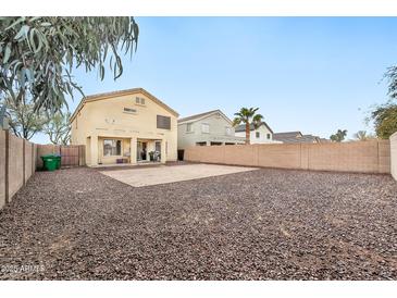 Spacious backyard with gravel and a covered patio at 18963 N Vemto St, Maricopa, AZ 85138
