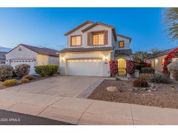 Two-story house with a large garage and landscaped front yard at 26234 W Behrend Dr, Buckeye, AZ 85396
