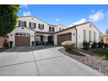 Elegant two-story home featuring a three-car garage, manicured landscaping, and a welcoming entrance at 2901 E Iris Dr, Chandler, AZ 85286