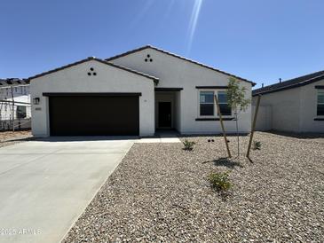 Charming single-story home with a low-maintenance desert landscape and a two car garage at 46905 W Old Timer Rd, Maricopa, AZ 85139
