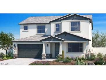 Two-story home with gray and white exterior, and a two-car garage at 4928 W Capistrano Ave, Laveen, AZ 85339