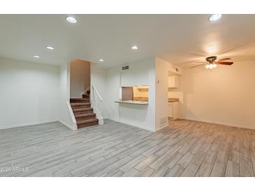 Spacious living room with tile floors and kitchen bar at 8446 N 34Th Dr, Phoenix, AZ 85051