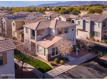 Charming home with a balcony, desert landscaping, and a red tile roof at 17749 W Woodrow Ln, Surprise, AZ 85388