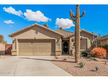 Single-story home with desert landscaping and two-car garage at 19601 N Krupps Ct, Maricopa, AZ 85138