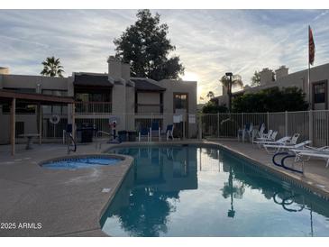 Inviting community pool with spa and lounge chairs at 205 N 74Th St # 205, Mesa, AZ 85207