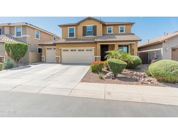 Two-story home featuring a three-car garage, desert landscaping, and a classic-style facade at 3501 E Apricot Ln, Gilbert, AZ 85298