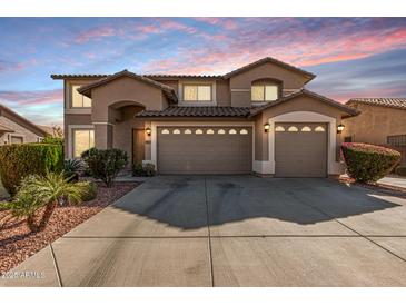 Beautiful home featuring a three car garage, mature landscaping and tile roof at 7461 W Tumblewood Dr, Peoria, AZ 85382