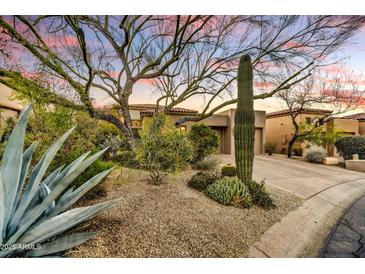 Desert landscaping with mature trees and cacti surrounds this lovely home at 7500 E Boulders Pkwy # 11, Scottsdale, AZ 85266