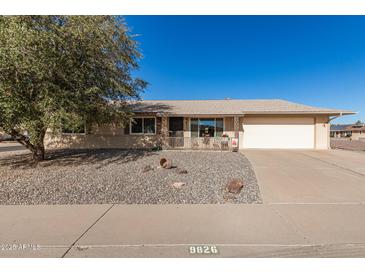 Ranch style home with a carport and well-manicured front yard at 9826 W Emberwood Dr, Sun City, AZ 85351