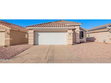 House exterior featuring a two-car garage and landscaped yard at 10506 W Pasadena Ave, Glendale, AZ 85307